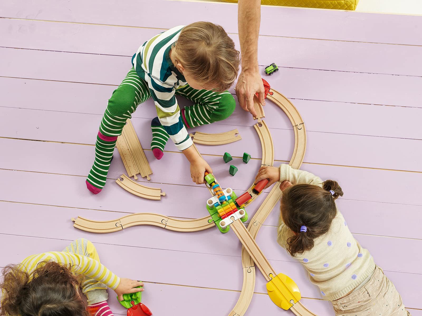 Children playing with a BRIO My First Railway set on the floor